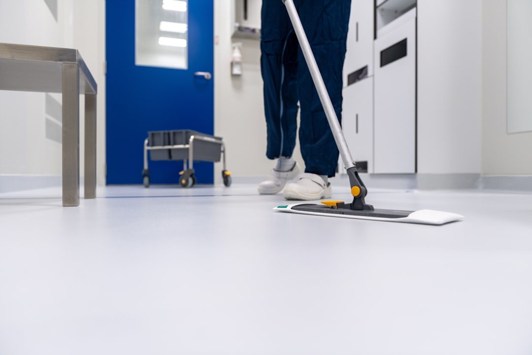 Cleaner cleaning the floor in a laboratory environment